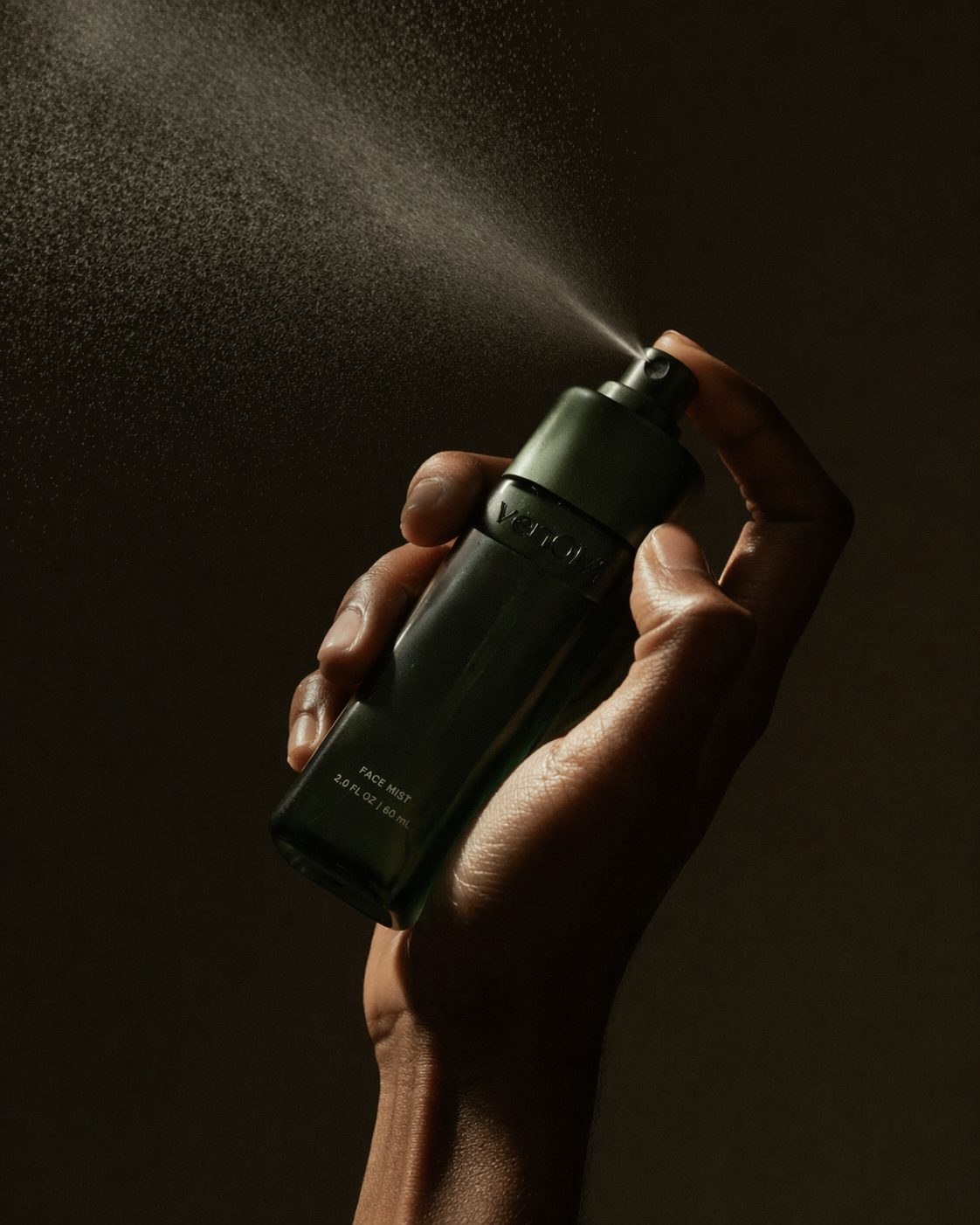Venom Face Mist being sprayed, backlit